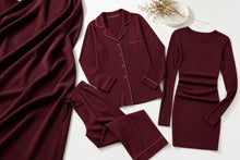 A coordinated women's loungewear set in deep burgundy, laid out on a light neutral background. The set includes a long-sleeve button-front pajama top with collar and pocket, matching drawstring pants, a long-sleeve fitted top, and a matching long-sleeve dress.