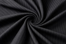 Dark charcoal gray pinstriped fabric arranged in a spiral drape, showing fine white vertical stripes and a smooth texture.