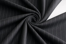 Black pinstriped fabric draped in a spiral pattern, showing fine vertical white stripes and a smooth texture.