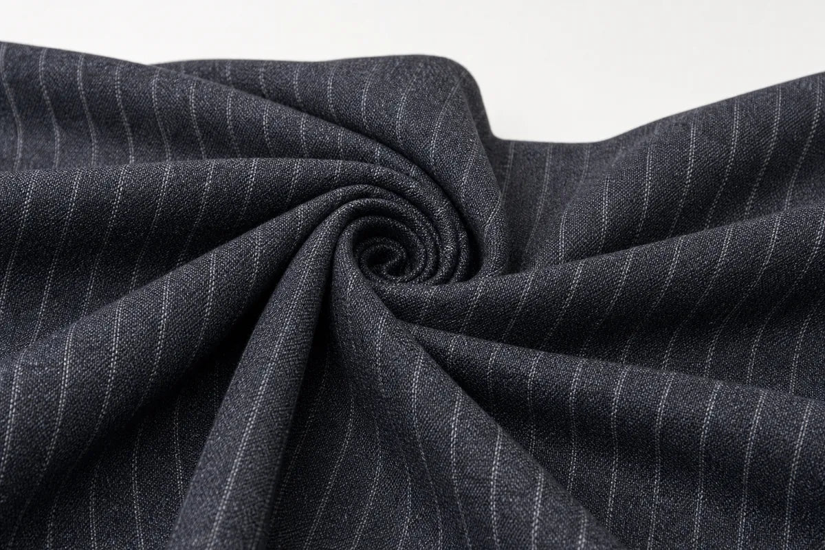 Dark charcoal gray fabric with thin white pinstripes, styled in a spiral drape against a plain white background.