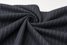 Dark charcoal gray fabric with thin white pinstripes, styled in a spiral drape against a plain white background.