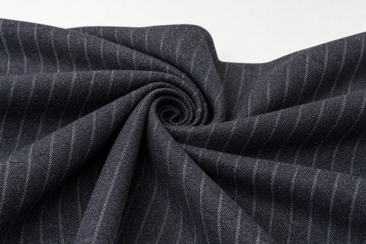Dark charcoal gray fabric with thin white pinstripes, styled in a spiral drape against a plain white background.