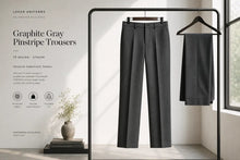 A pair of Graphite Gray Pinstripe Trousers from Luxor Uniforms displayed on a black clothing rack, with a matching folded pair hanging to the right. The background is a clean, modern room with a window, and the left side features a text panel detailing the product specifications.