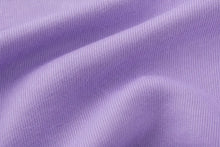 A close-up of lavender purple ribbed knit fabric with soft folds and a smooth texture.