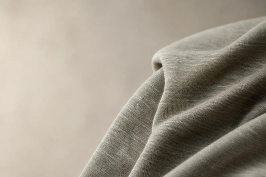 Close-up of textured green fabric on a beige background