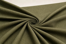 A close-up of olive green fabric draped in a spiral pattern, showing its texture and color against a light background.