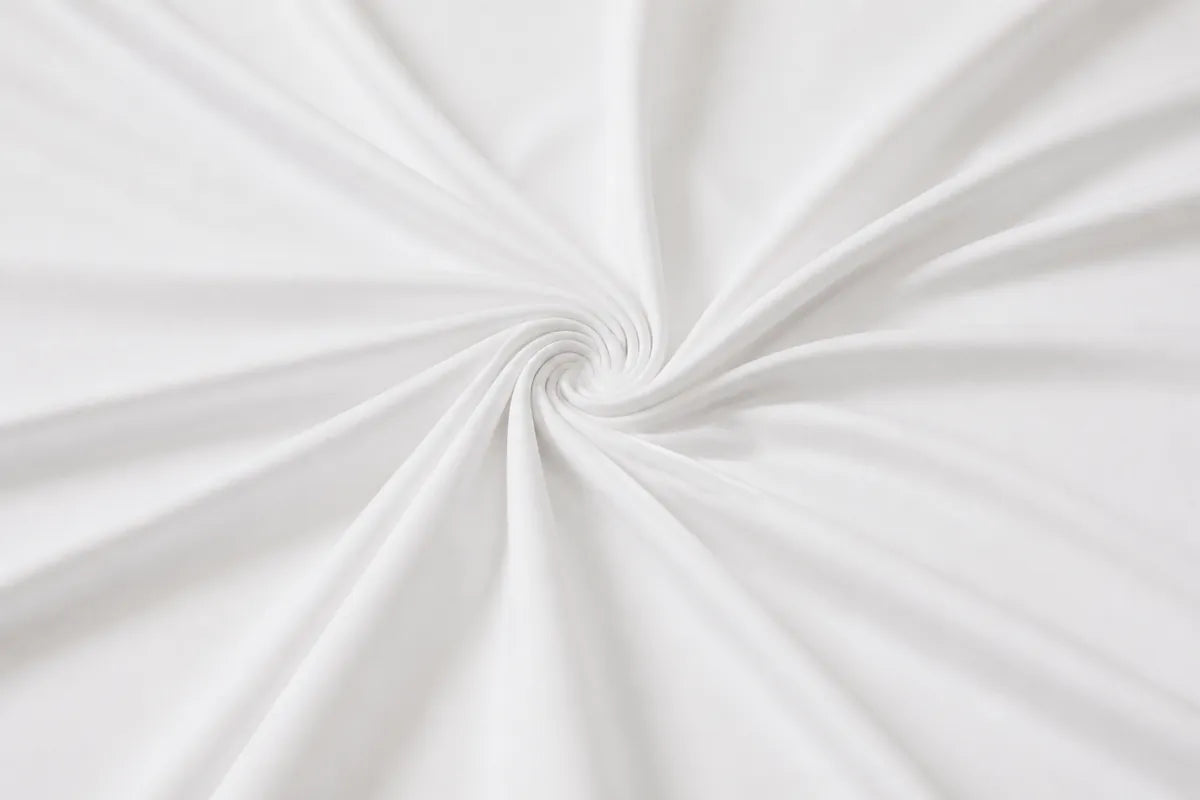 White fabric with a smooth texture, elegantly draped and twisted into a spiral pattern.
