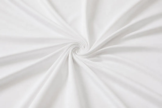 White fabric with a smooth texture, elegantly draped and twisted into a spiral pattern.