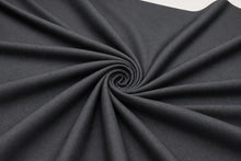Dark charcoal gray fabric draped in a spiral pattern to show its texture and drape.