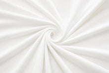 White fabric draped in a spiral swirl pattern, showing soft folds and a smooth texture.